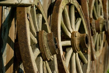 old wooden cart wheels on barn wallの写真素材