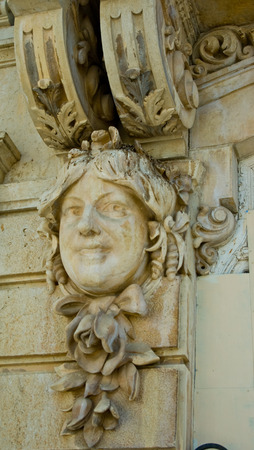 decoration of statue head on a wall on a  buildingの写真素材