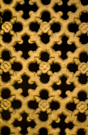 painted golden color metal window grate as pattern backgroundの写真素材