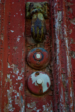 closeup detail of aged door bells and handle on a  painted doorの写真素材