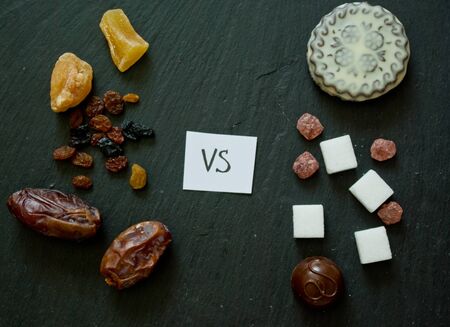 concept of choice between healthy natural sweets and artificial unhealthy sugars and candiesの写真素材