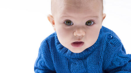 close up of a baby with brown green eyesの写真素材