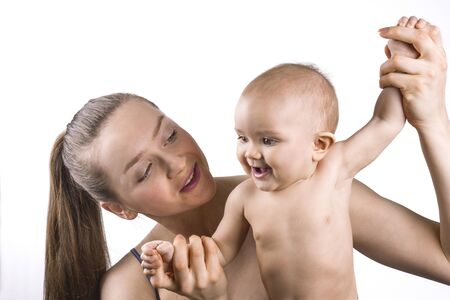 Young mother holding her baby and smiling together on white background.の写真素材