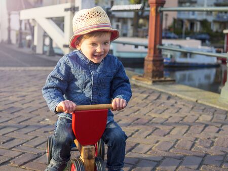 Cute toddler riding his tricycle in Amsterdamの写真素材