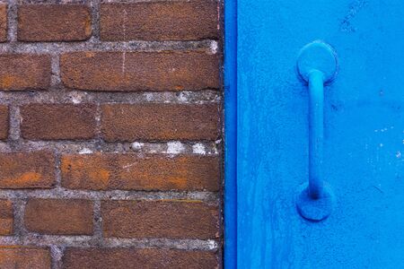Brick wall and blue doorの写真素材