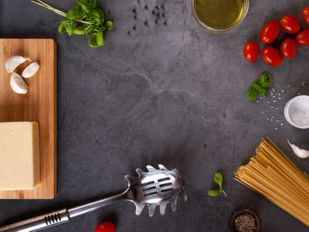 Frame made of Italian pasta ingredients: spaghetti, pasta, tomato, basilisk, cheese, olive oil, pepper, and saltの写真素材