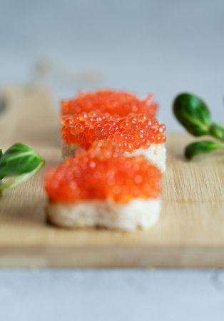 Red caviar canapes in the shape of the heart, tasty healthy foodの写真素材