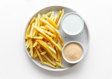 Fresh fried french fries with 2 sauces isolated on white background. Top viewの写真素材