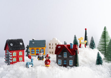 Stylish little Christmas trees and houses decorations. miniature cozy snowy village.の写真素材