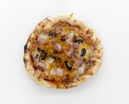 Honey pizza with mozzarella cheese,bacon, champignons, honey isolated on white background. Pizza top view.の写真素材