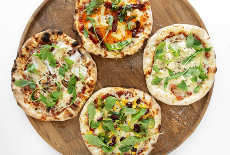 4 pizzas on wooden background.Isolated on white background. Pizza top view. Pizza top view.
