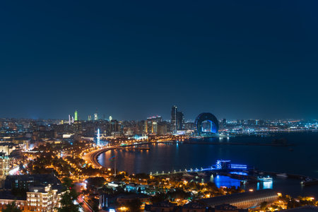 Baku, Azerbaijan - June 5, 2024. View of the Crescent Bay business center and Port of Baku from the upland park. Evening Baku Boulevard.の写真素材