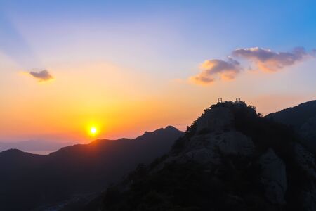 Sunset in the evening, cloudy with mountains and beautiful red orange sky.の写真素材