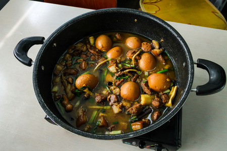 Stewed eggs in a pot placed on the table