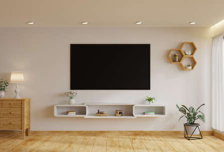 TV in the living room on a white wall by the window, decorated with plants, vases, flowers, toys and...