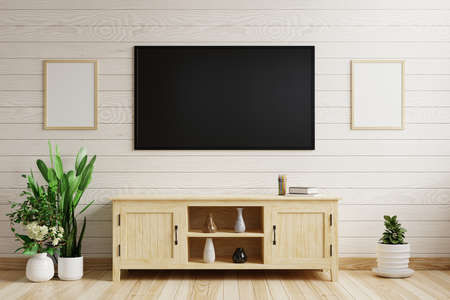 Tv on the white wooden wall In the living room decorated with wooden cabinets and plant pots on the...