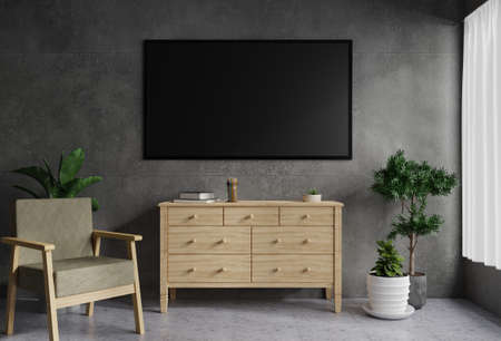 TV on the concrete wall in the living room is decorated with a wooden table. There was a plant pot on the side and an armchair on the tile floor.3d renderingの写真素材