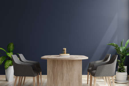 Meeting room with armchairs and desks on wooden floors. Decorated with plant pots on the sides and a dark wall as a background.3d renderingの写真素材