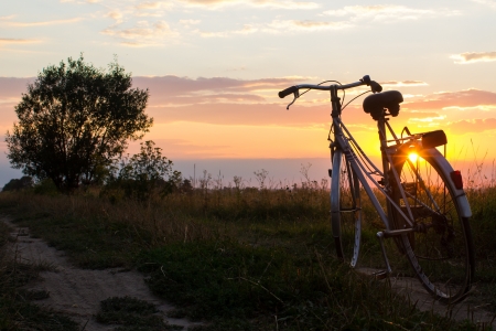 Bicycle standing on road in sunlightの写真素材
