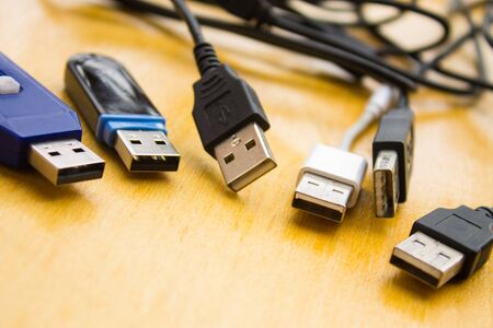 Many different USB cables on tableの写真素材