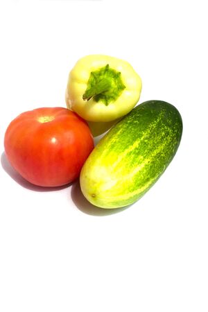 Red tomato, green cucumber and yellow pepper  on white backgroundの写真素材