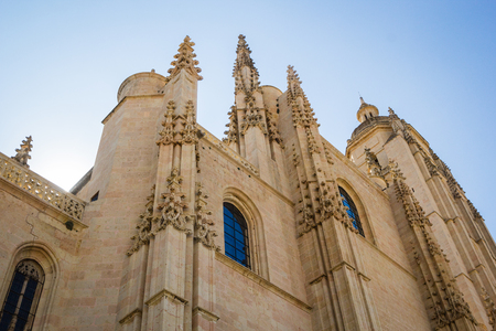 Closeup of sculptureas and architecture of Segovia cathedral in Spain with blue sky backgroundのeditorial素材
