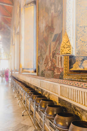 Row of golden Buddist alms bowls in Wat Pho Wat Phra Chetuphon temple in Bangkok, Thailandのeditorial素材
