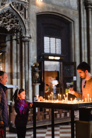 Vienna, Austria - March 23, 2019: People putting memorial candles in St. Stephen's Cathedral in Vienna, Austria, holy catholic serviceのeditorial素材