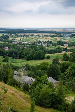 Scenic view on Pidkamin inselberg on adjacent hill and nearby village in Brody region of Galychyna,...