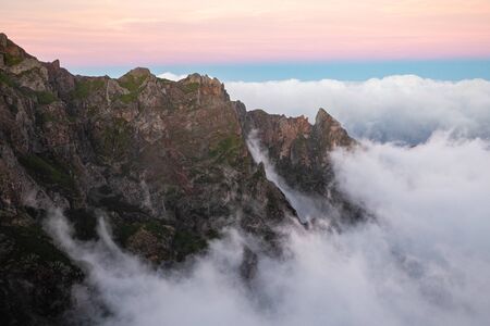 Beautiful cloudy mountains sunset view, clouds above mountain peaks with bright sky background