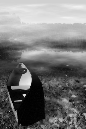 Boat on a misty lakeの写真素材