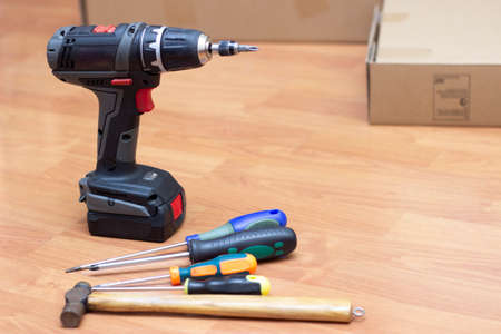 drill and other home work tools on the wooden floorの写真素材