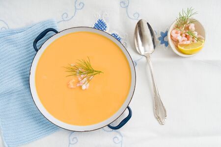 Shrimp soup garnished with fresh shrimps and a lemon wedgeの写真素材