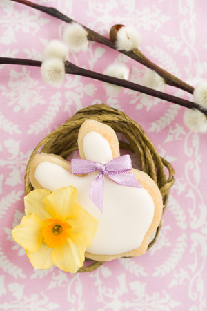 Easter bunny sugar cookie with hair ribbon in a nest