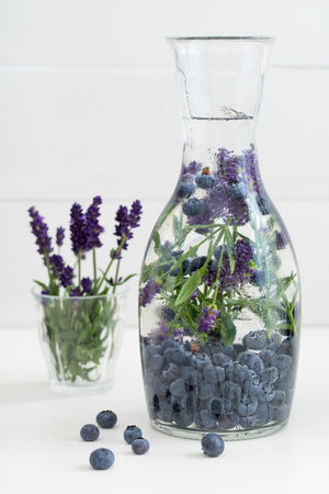Infused water with blueberries and lavender in a pitcherの写真素材