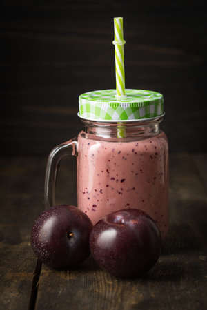 Healthy pink smoothie with red plums and yogurtの写真素材