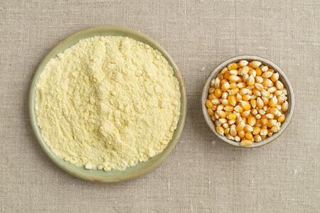 Corn and cornmeal in small bowls shot from above