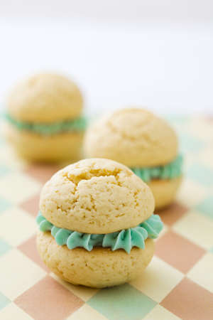 Vanilla whoopie pies with turquoise buttercream fillingの写真素材