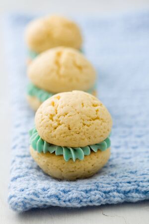 Vanilla whoopie pies with turquoise buttercream fillingの写真素材