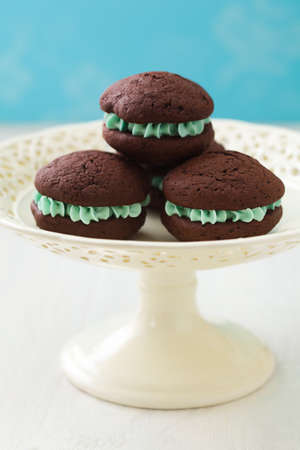 Chocolate whoopie pies with turquoise buttercream fillingの写真素材