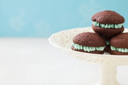 Chocolate whoopie pies with turquoise buttercream fillingの写真素材