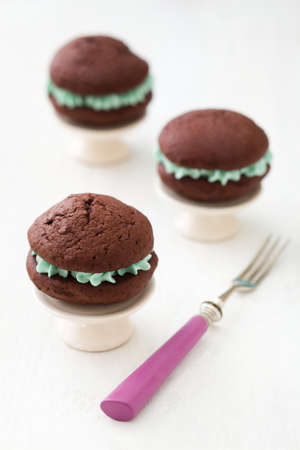 Chocolate whoopie pies with turquoise buttercream fillingの写真素材