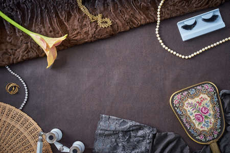 Overhead flat lay shot of feminine objects a woman uses in preparation for a visit at the opera or theaterの写真素材