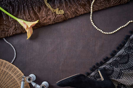 Overhead flat lay shot of feminine objects a woman uses in preparation for a visit at the opera or...