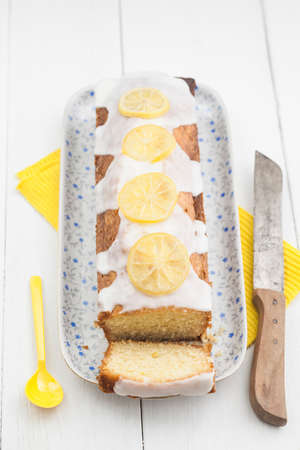 Lemon cake with icing decorated with lime slicesの写真素材