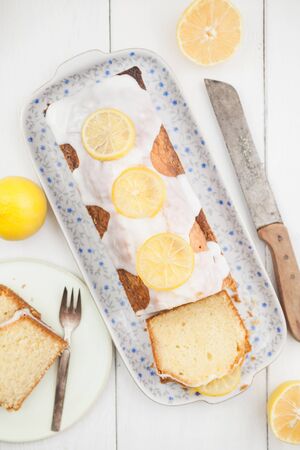 Lemon cake with icing decorated with lime slicesの写真素材