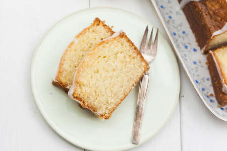 Lemon cake with icing decorated with lime slicesの写真素材