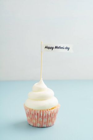 Mothers day cupcake with buttercream frosting on turquoiseの写真素材