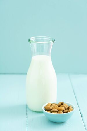 Fresh homemade almond milk in a bottle with fresh almondsの写真素材