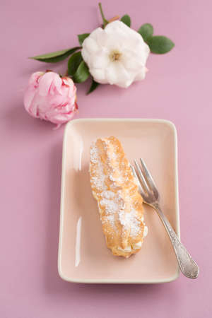 Eclairs with buttercream filling and powdered sugarの写真素材